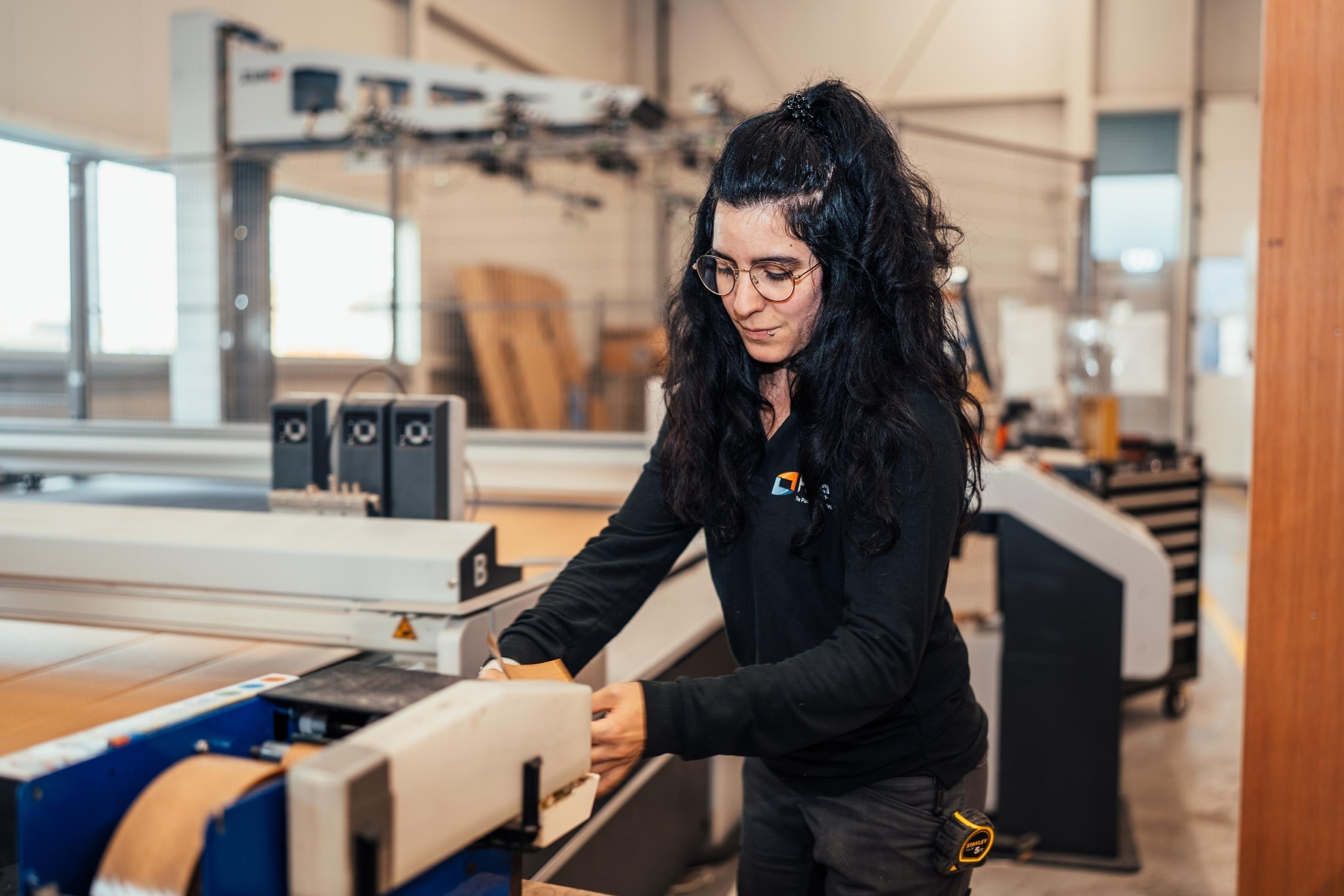Medewerker van Faes bedient een machine in de productieomgeving, passend bij een artikel over TCO en het afwegen van hogere investeringen in passende verpakkingsoplossingen.